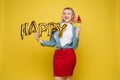 Cheerful girl with inflatable letters HAPPY.Stock photo portrait of attractive girl with red lips holding shining bright