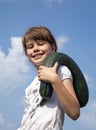 Cheerful girl is in the kitchen-garden, collecting zucchini