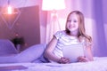 Cheerful girl lying on the bed with her tablet Royalty Free Stock Photo