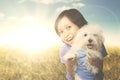 Cheerful girl with Maltese dog on the meadow Royalty Free Stock Photo
