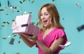 Cheerful girl opening gift box with interest Royalty Free Stock Photo