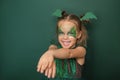 A cheerful Girl with a painted face with dragon image laughs looking at camera Royalty Free Stock Photo