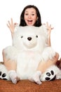 Cheerful girl plays with a teddy bear Royalty Free Stock Photo