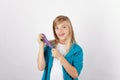 Cheerful girl posing with her handmade purple slime