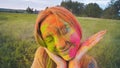 Cheerful girl posing smeared in multi-colored powder. Close-up face. Royalty Free Stock Photo