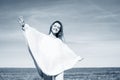 Cheerful girl with raised hands on the field in warm autumn season. Royalty Free Stock Photo