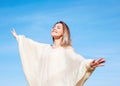 Cheerful girl with raised hands on the field in warm autumn season. Royalty Free Stock Photo