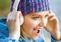 Cheerful girl rejoicing listening music in headphones smiling. Girl listens to music in headphones. Listening to music Royalty Free Stock Photo