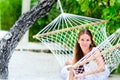 Cheerful girl relaxing in hammock