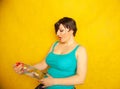 Cheerful girl with short hair with a big bottle of water on a yellow background in the Studio Royalty Free Stock Photo