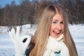 Cheerful girl shows tongue in park. Frosty morning in the park