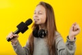 Cheerful girl sings into a microphone. Little Star, show business Royalty Free Stock Photo