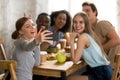 Happy friends take selfie photo sitting in cafe Royalty Free Stock Photo