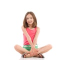 Cheerful girl sitting with legs crossed Royalty Free Stock Photo