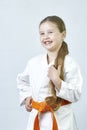 Cheerful girl sportswoman with an orange belt