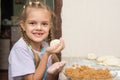 Cheerful girl stained with flour made patty with cabbage Royalty Free Stock Photo