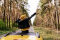 Cheerful Girl Stand out of Car Sunroof Back View