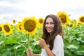 Cheerful girl standing in a sunflower field Royalty Free Stock Photo