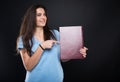 Cheerful girl student pointing at her album Royalty Free Stock Photo