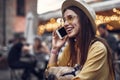 Cheerful girl talking on cellphone on blurred background with bokeh effect Royalty Free Stock Photo