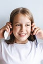 Cheerful girl talking on white push-button phone and smartphone vertical view