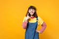 Cheerful girl teenager in french beret with closed eyes, horns up gesture, depicting heavy metal rock sign, rock-n-roll