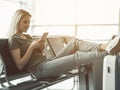 Cheerful girl typing in cellphone on bench Royalty Free Stock Photo