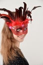 Cheerful girl with venetian feather mask