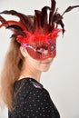 Cheerful girl with venetian feather mask