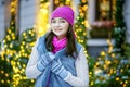 A cheerful girl walks along the street at Christmas. Concept Lifestyle, Urban, Winter, Vacation, Happy Christmas, New Year