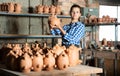 Girl showing finished ceramic production