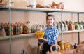 Girl showing finished ceramic production