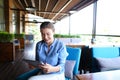 Cheerful girl working with tablet at restaurant table.