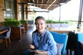 Cheerful girl working with tablet at restaurant table.