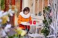 Cheerful girl writing Christmas cards in cafe