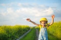 Cheerful girl in a yellow hat in a summer field laughs and smiles. Joy, sunny weather, holidays.Repellent for mosquitoes and Royalty Free Stock Photo