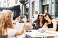 Young beautiful girls sit in a cafe outdoor