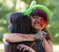 Cheerful girls in color powder hugs