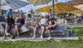 Cheerful girls and guys enjoying beer and drinks at Gripsholm`s inn dining one summer day