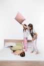 cheerful girls in pajamas having pillow Royalty Free Stock Photo