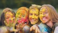 Cheerful girls posing smeared in multi-colored powder. Royalty Free Stock Photo