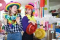 cheerful girls together looking for festival hats Royalty Free Stock Photo