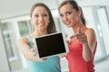 Cheerful girls showing a tablet