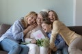 Cheerful girls and women congratulating eldest great grandma on birthday