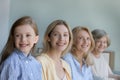 Cheerful girls and women of four female generations posing indoors Royalty Free Stock Photo