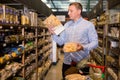 Cheerful male customer choosing pasta in supermarket