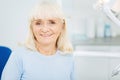 Cheerful glance of satisfied woman at dentists