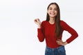 Cheerful good-looking sassy brunette girl in red sweater standing unbothered and carefree, holding hand on hip, laughing