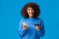 Cheerful good-looking smiling african-american woman buying online, shopping during discounts holiday season, smiling Royalty Free Stock Photo