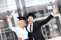 Cheerful graduates outside university